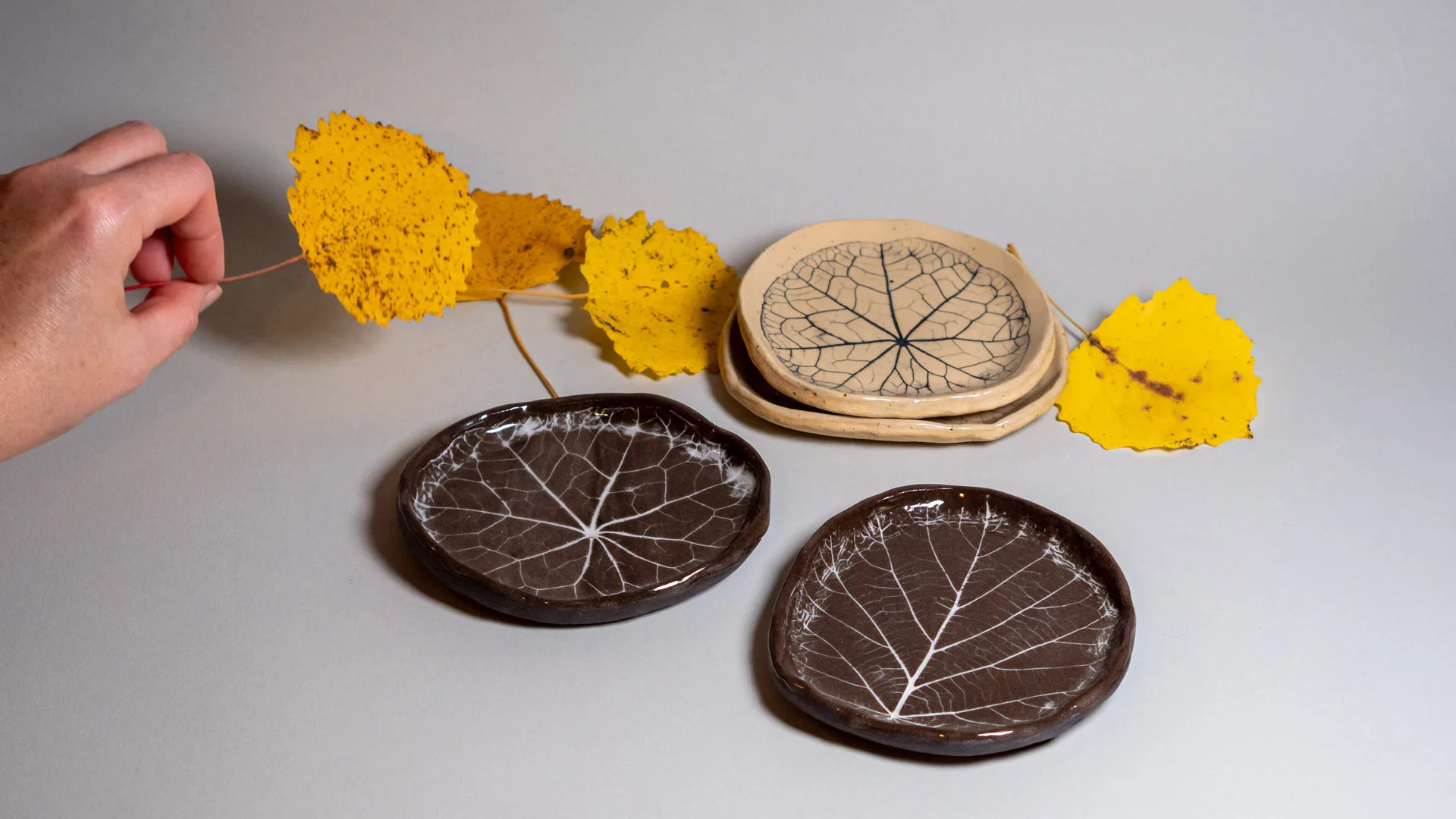 Plates with leaves embossed to the clay. Made by Kaia Klementi