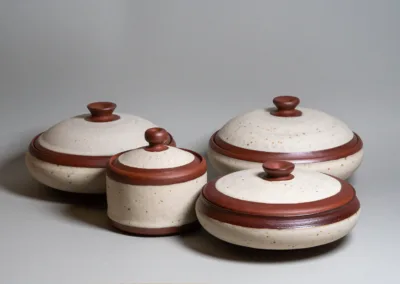 Shallow lidded jars from red stoneware and buff speckled glaze