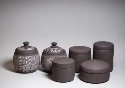 Storage jars from black stoneware, unglazed from outside