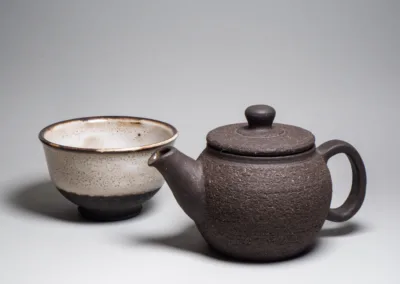 Black stoneware teapot and a tea bowl
