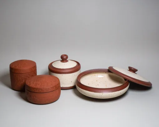 Lidded jars from red clay and buff speckled glaze