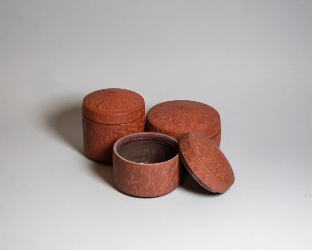 Lidded jars from red stoneware and chattered texture
