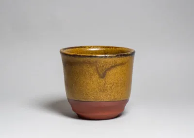 A cup of red stoneware and Tea Dust glaze