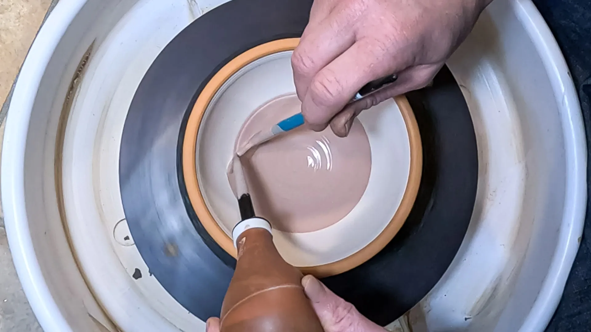 Brush glazing on the potters wheel