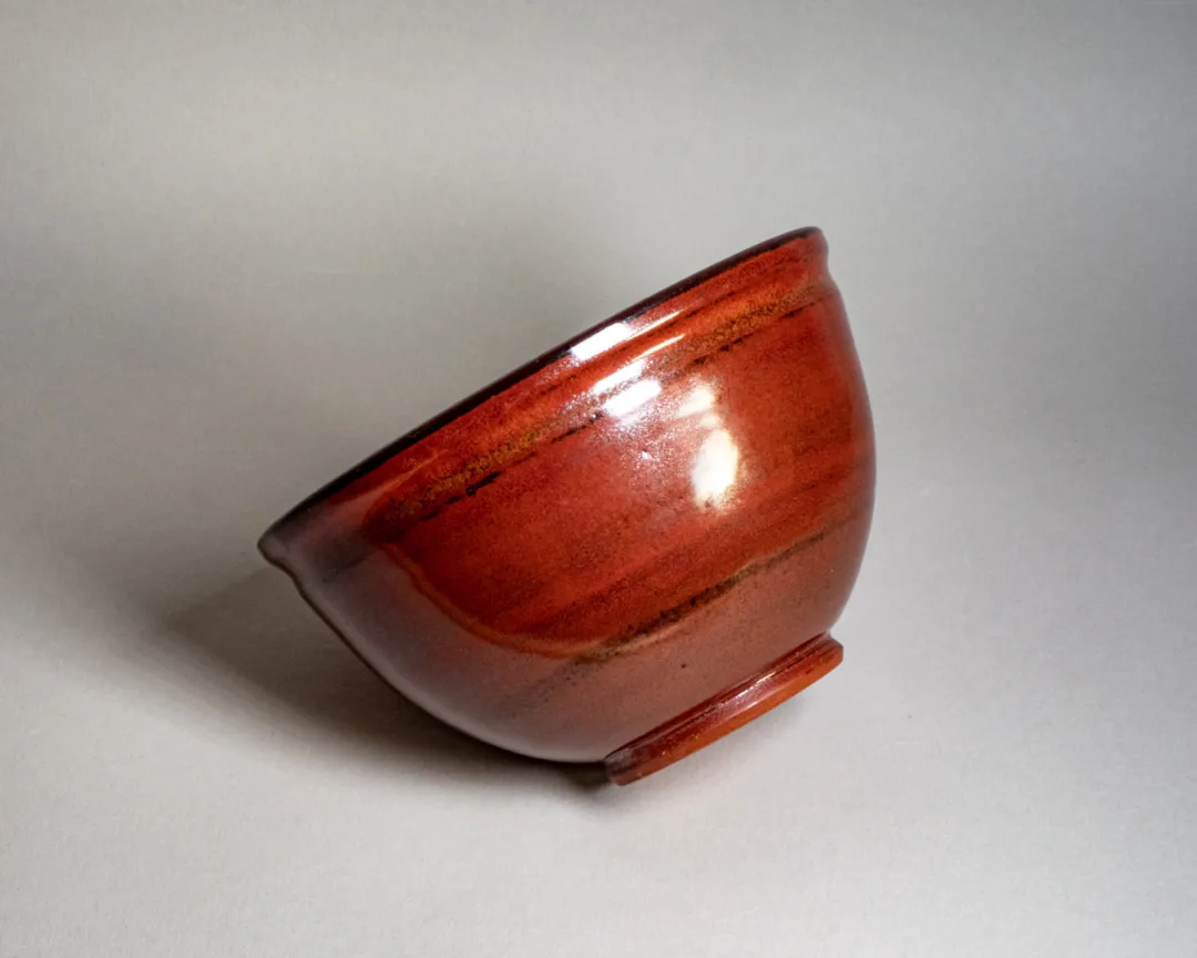 Salad bowl from red stoneware, side view