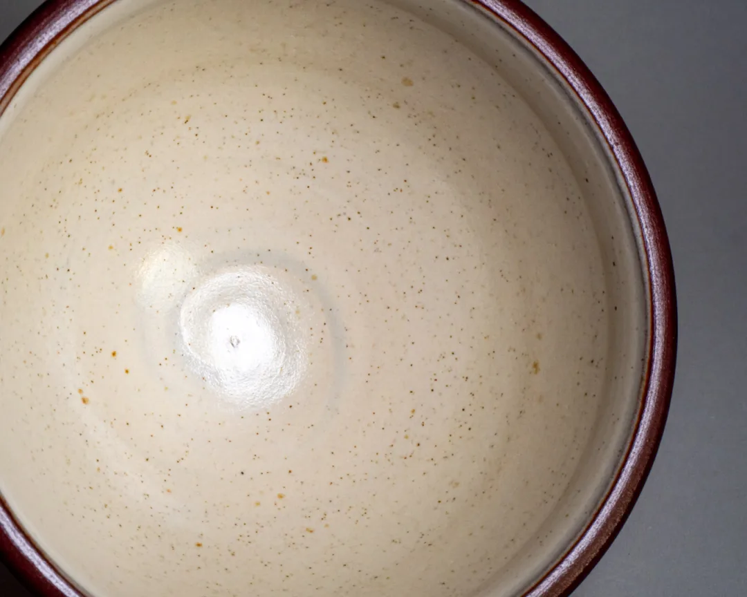 Salad bowl from red stoneware, speckled white glaze in the inside