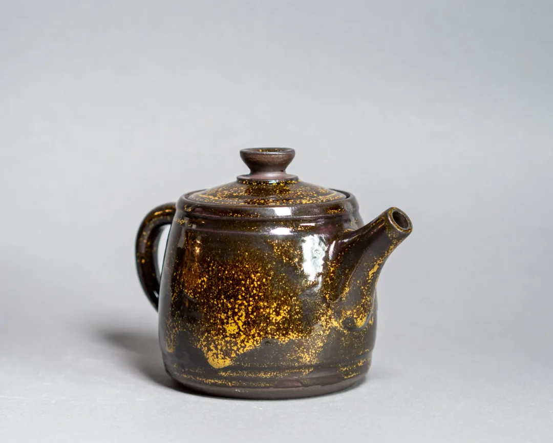 Small teapot from black clay and Teadust glaze
