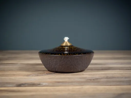 Oil lamp from dark clay covered with dark glaze with golden microcrystals and a brass wick holder 